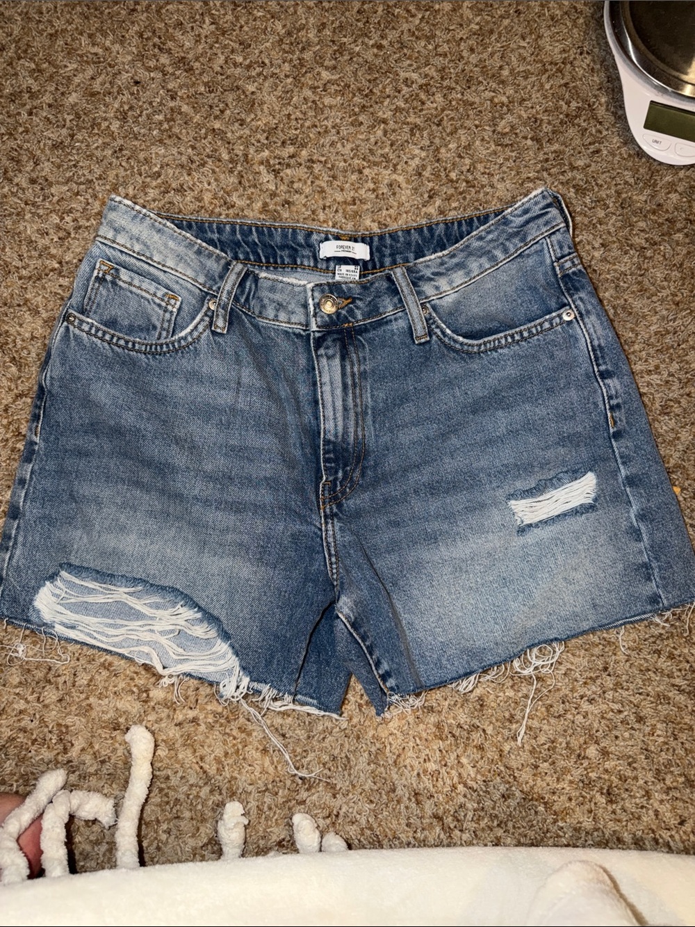 Forever 21 women's denim shorts feature a light wash and frayed raw hem